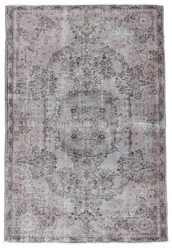 Full top view of the 5'7" x 8'5" vintage Anatolian area rug with a muted gray and rose medallion design.