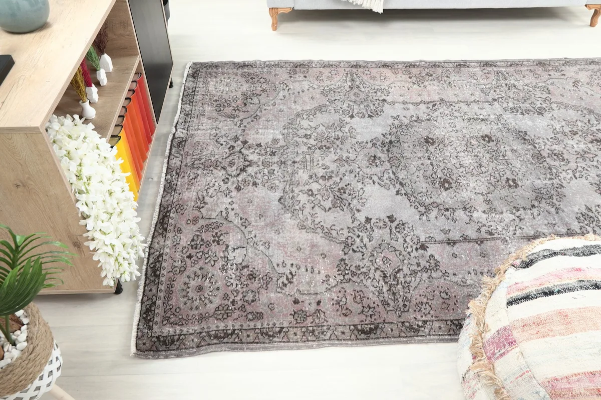 View of the rug in a room setting from a different angle, showing its placement under a console.
