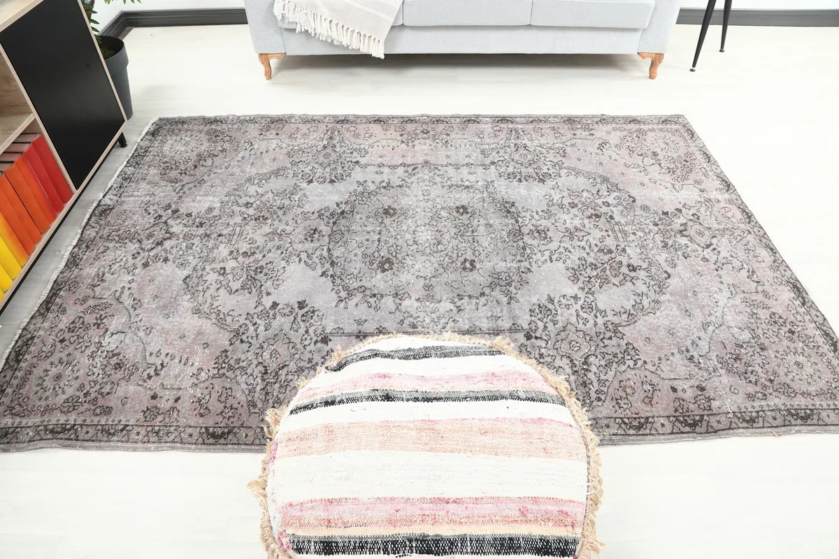 Frontal view of the rug in a room, emphasizing its medium size and central medallion design.