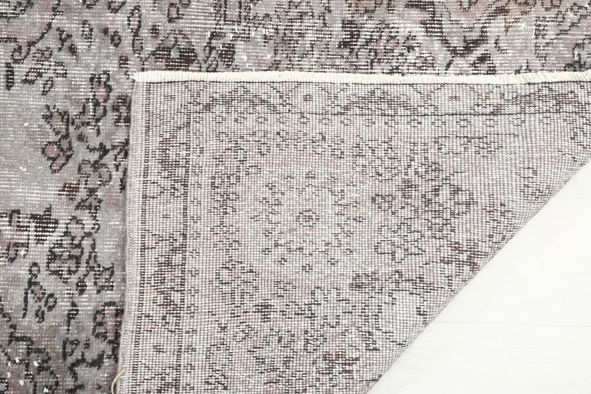 Close-up of the rug's reverse side, showing the tight knotting and craftsmanship of the cotton foundation.