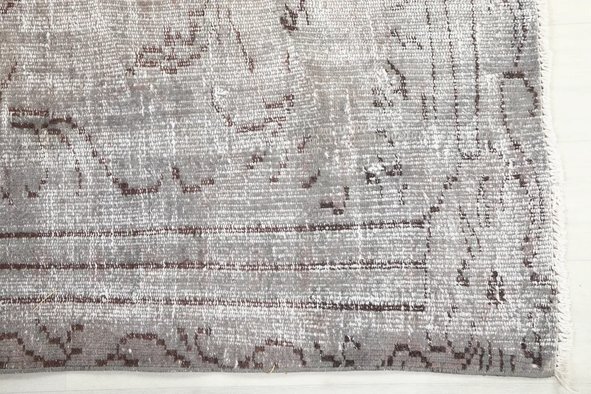 Close-up of the Gray Medallion Anatolian Rug's corner, revealing the geometric border and low pile.