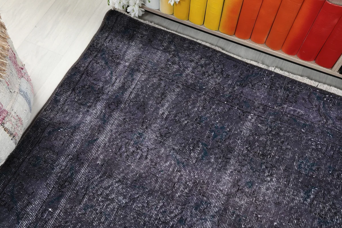 Corner view of the rug, illustrating the low pile and slightly irregular edges.