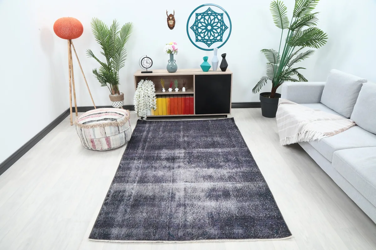 Charcoal and gray rug showcased in a modern living room setting with a light sofa.