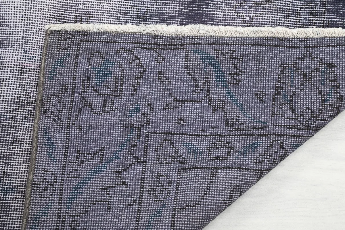 Detailed view of the rug's back, showing the consistent knotting and structure.