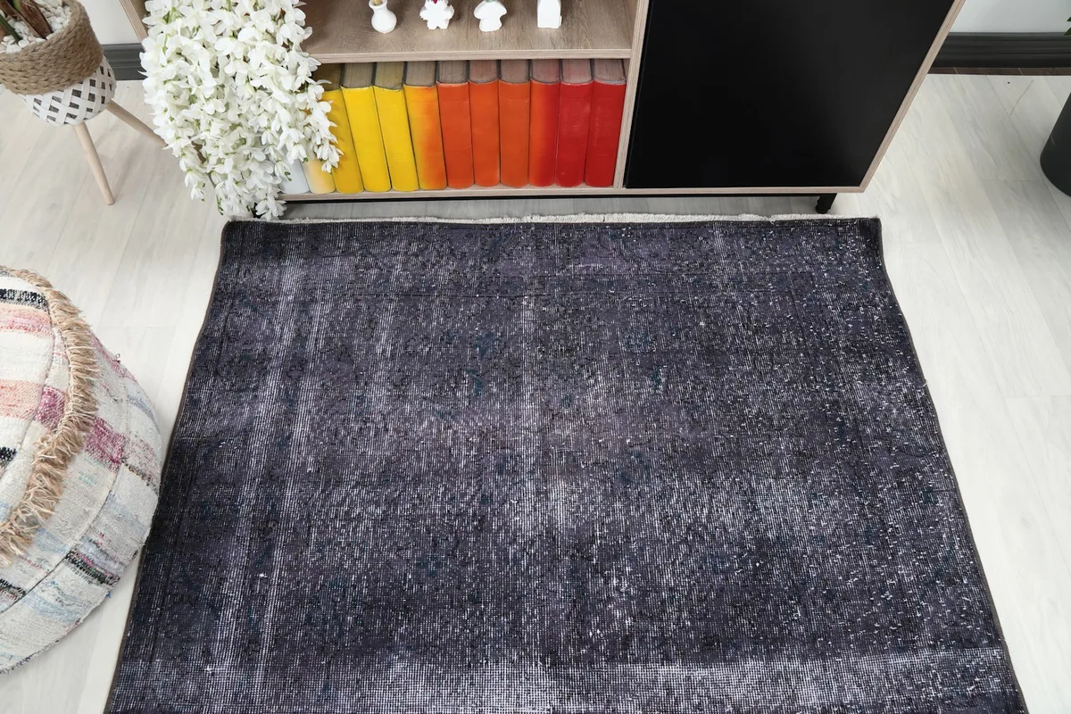 Overhead perspective of the rug, emphasizing its rectangular shape and overall distressed pattern.