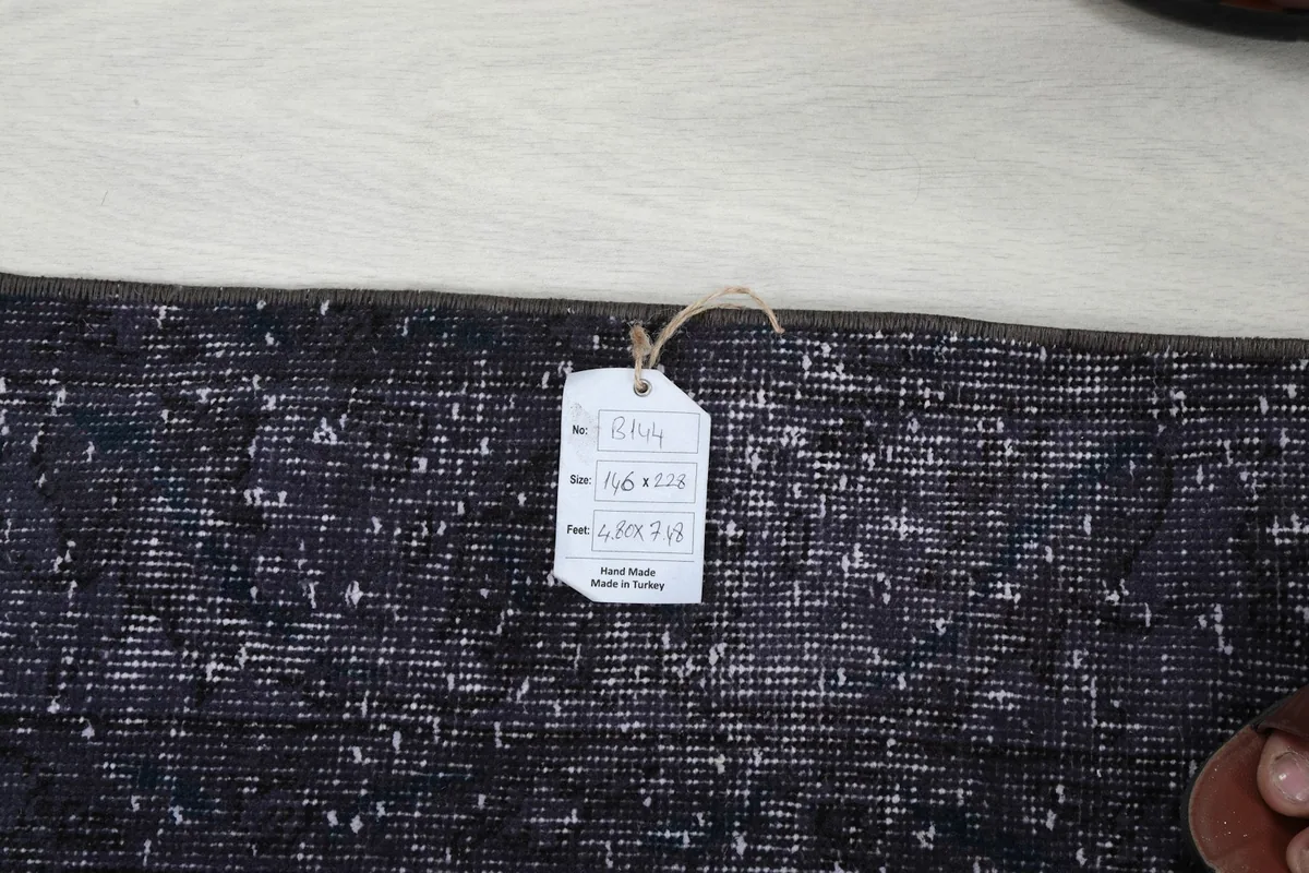 Product tag attached to the rug, displaying size and origin information.