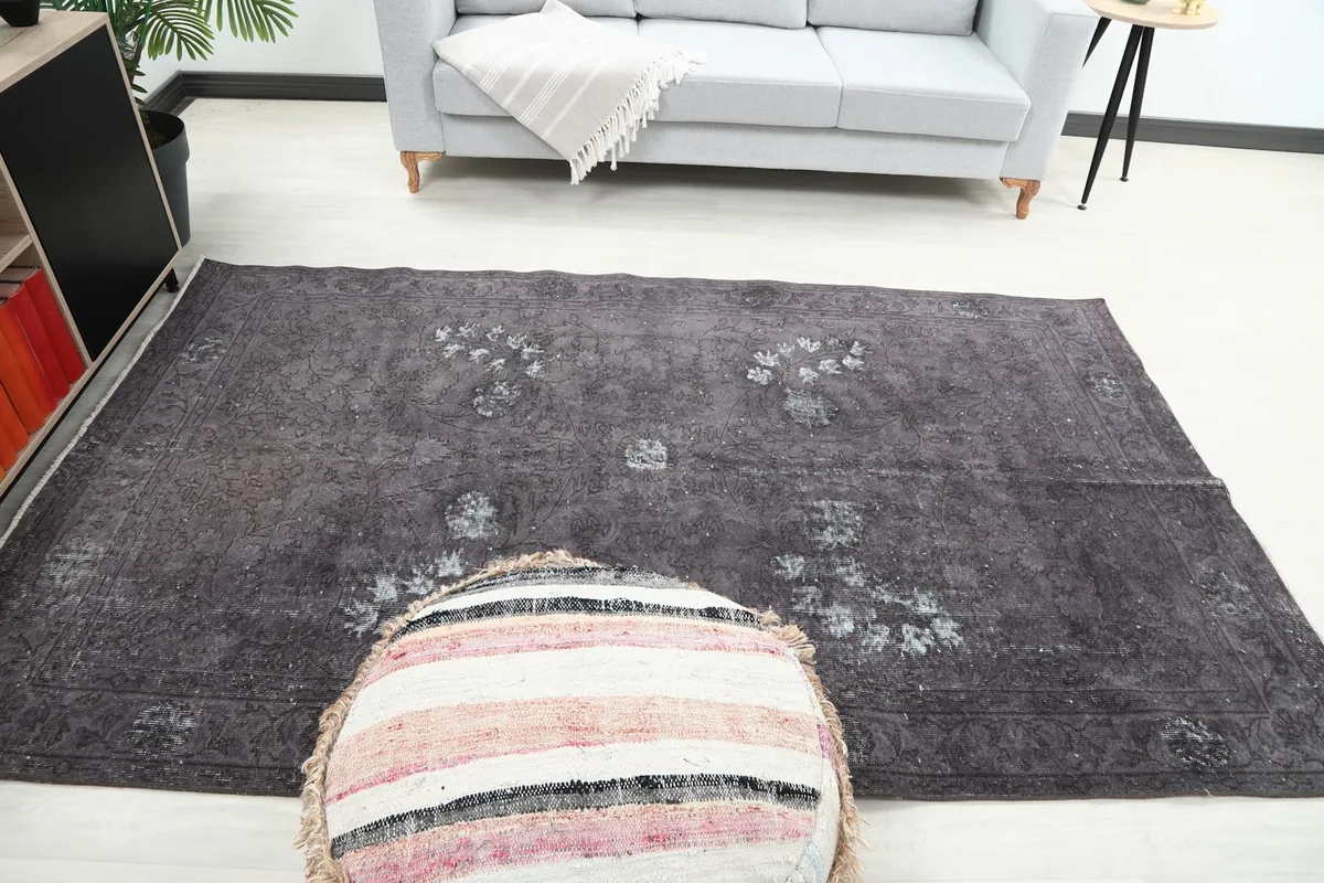 Full room view of the vintage charcoal rug, showcasing its medium size and design in a living area