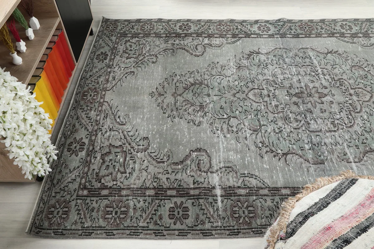 Angled view of the rug, capturing the interplay of gray and charcoal colors