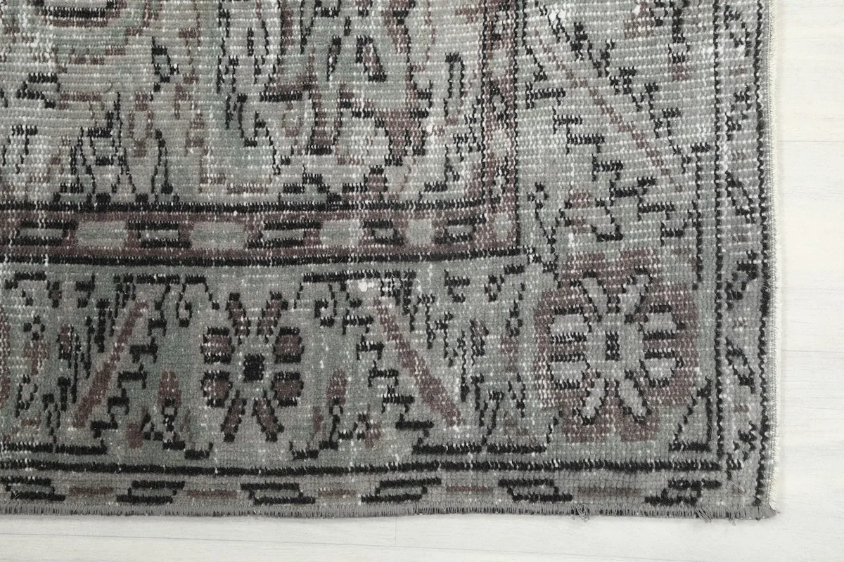 Detailed view of the rug's corner, showing the intricate border patterns and colors