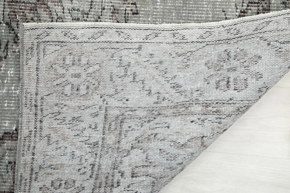 Close-up of the rug's back, revealing the hand-knotted structure and tight weave