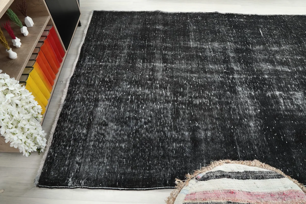 Angled view of the charcoal rug in a room, from a different perspective