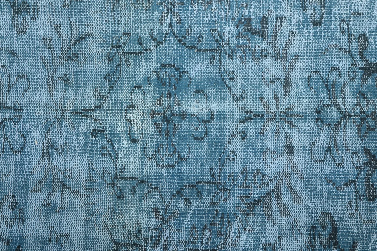Texture shot of the low pile wool surface, showing the subtle variations in blue color