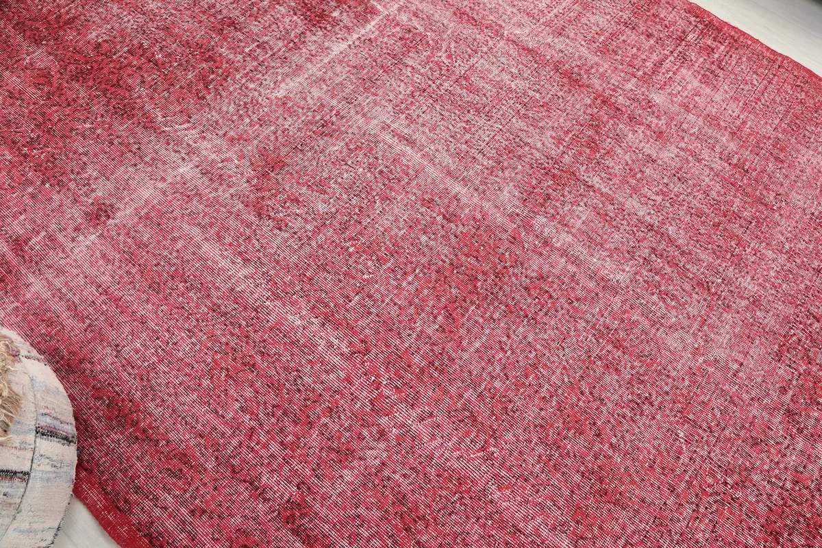 Diagonal perspective of the rose distressed rug, showing its overall faded aesthetic