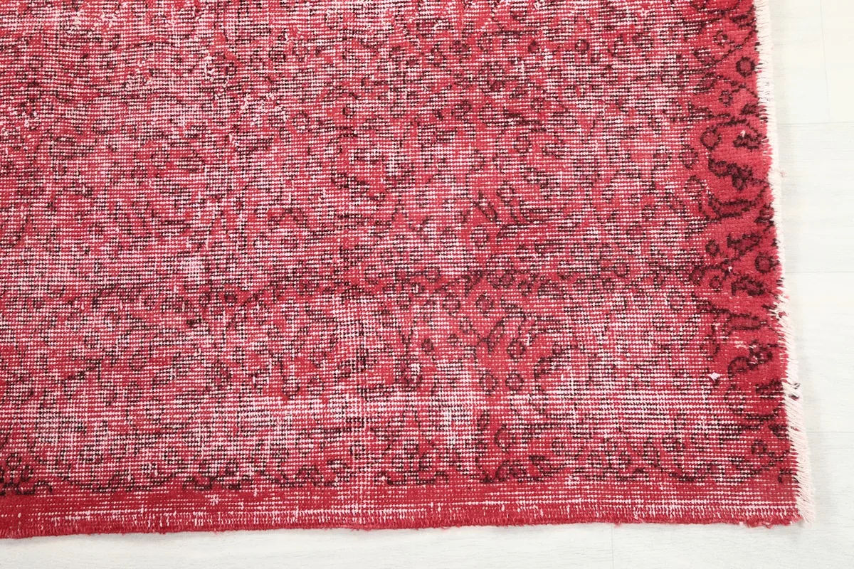 Detailed view of the distressed rose pile, revealing underlying charcoal geometric patterns