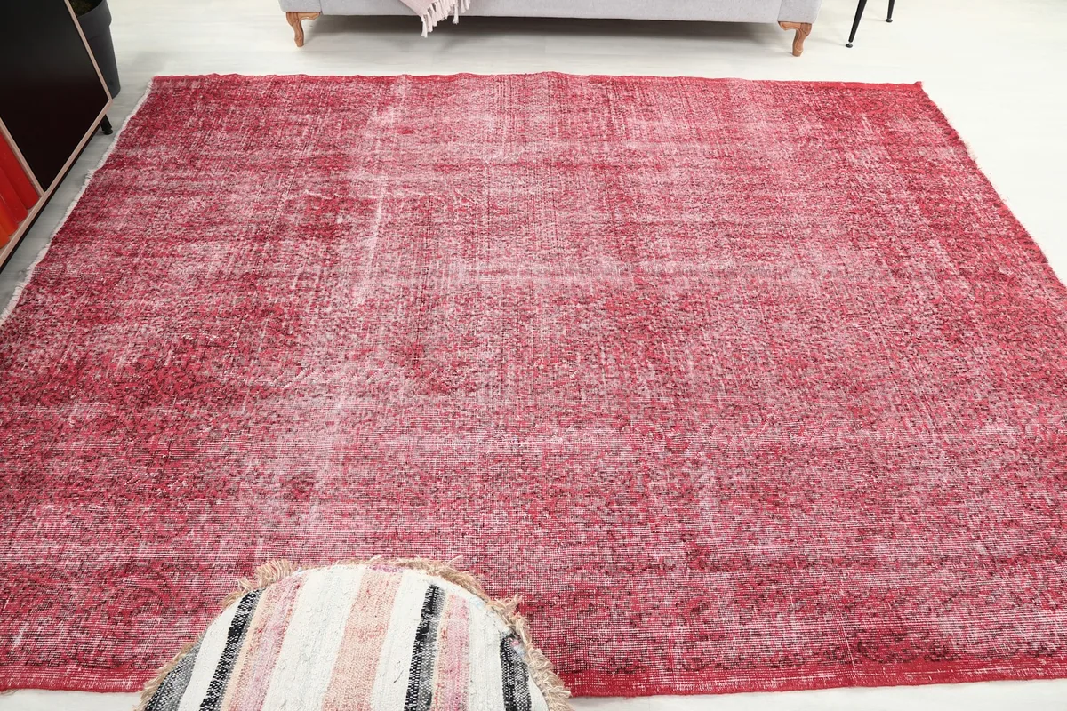 Full overhead shot of the rose vintage rug in a room, emphasizing its rectangular shape