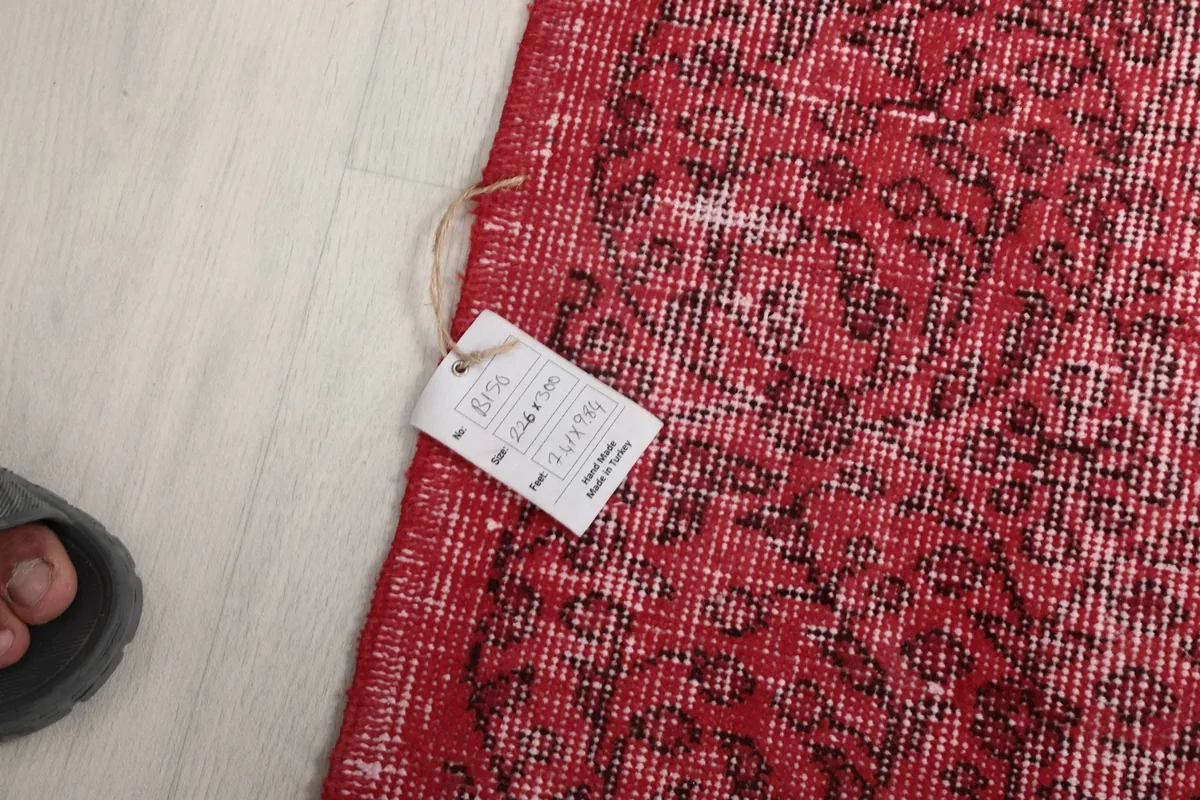 Detail of the rug's edge with a tag showing size and origin information