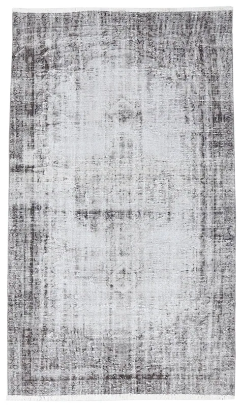 Full overhead view of the charcoal and ivory distressed vintage Anatolian area rug on a white background.