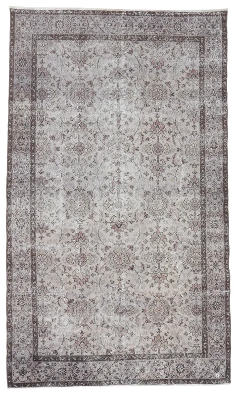 Full overhead view of the beige and brown floral vintage Anatolian area rug