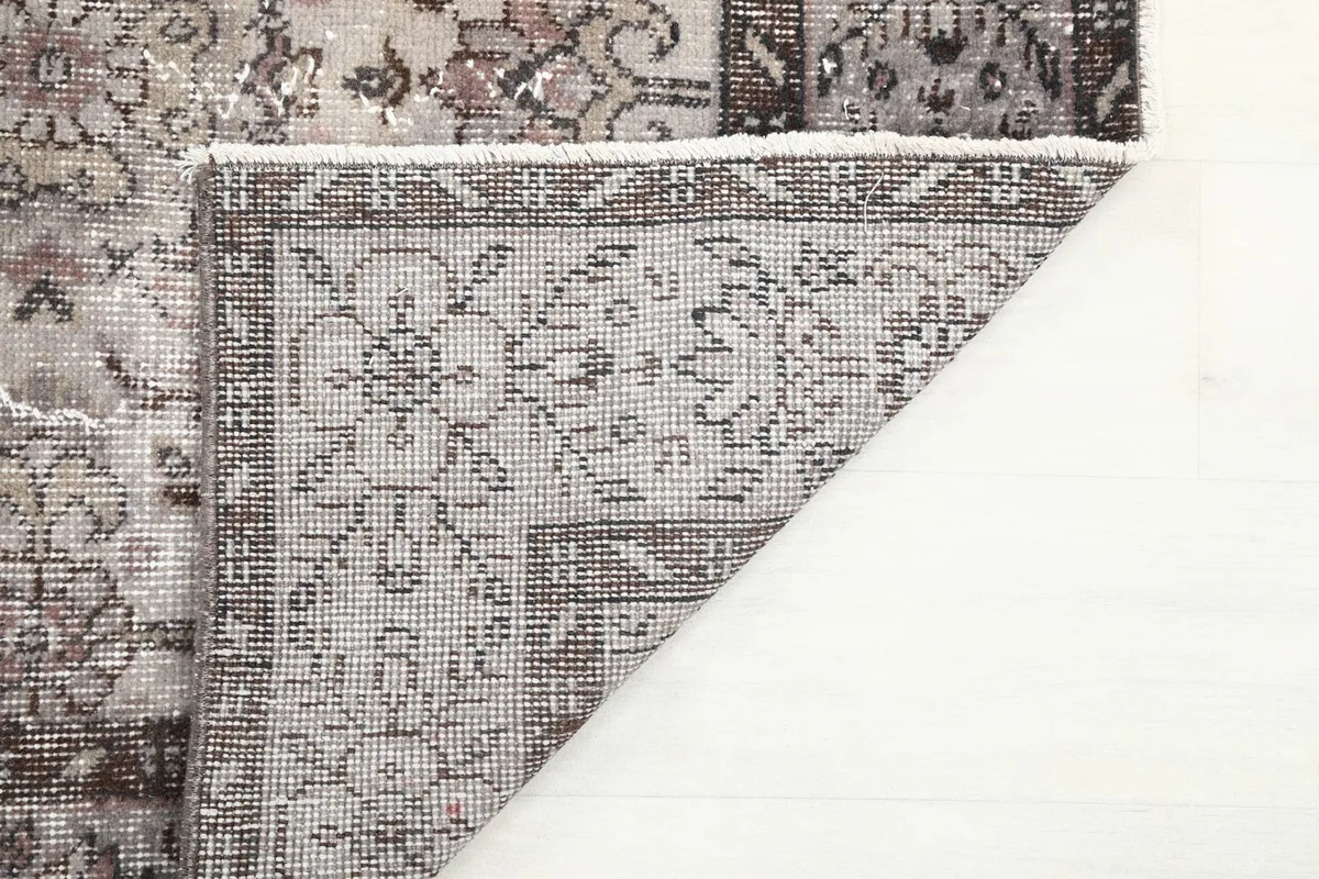 Close-up of the back of the rug, showing the dense hand-knotted foundation and knot work