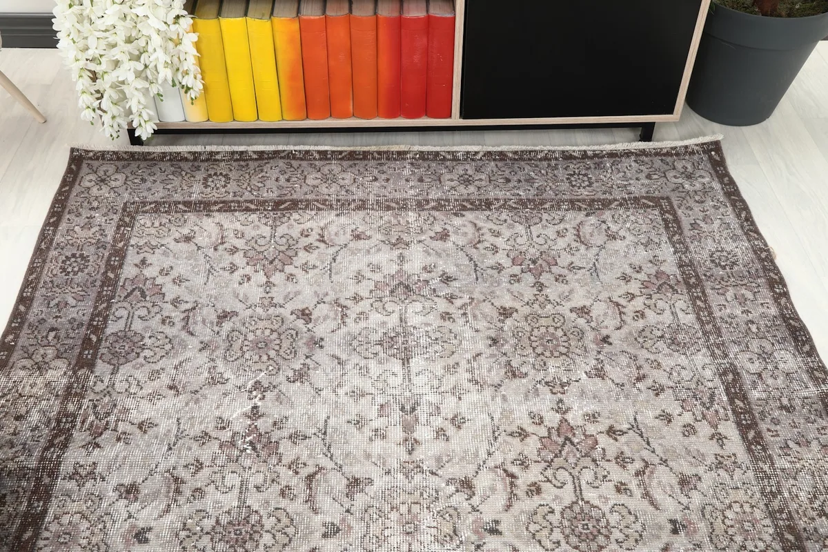 Overhead view of a section of the rug, highlighting the central floral design and border