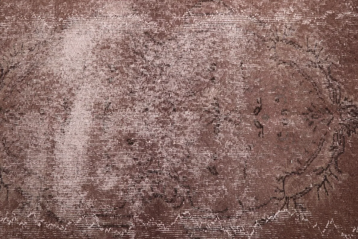 Overhead view showcasing the overall pattern and color variation of the rust rug