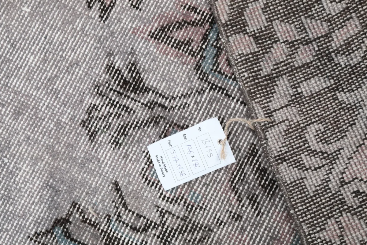 Detailed view of the rug's back with a product tag, showing the weave