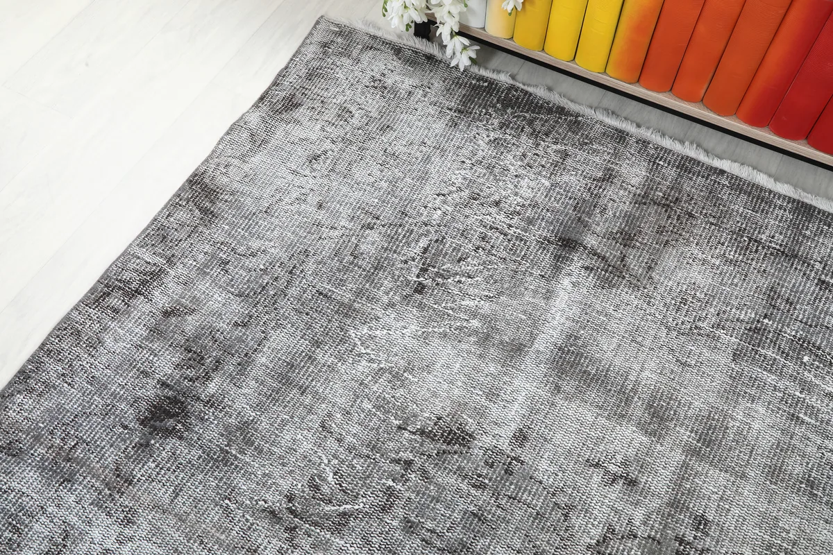 Corner view of the Charcoal Faded Abstract Rug, demonstrating its aged patina and soft texture.