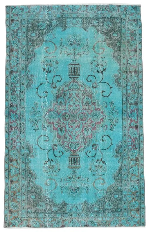 Full overhead view of the blue vintage Anatolian area rug with a central medallion