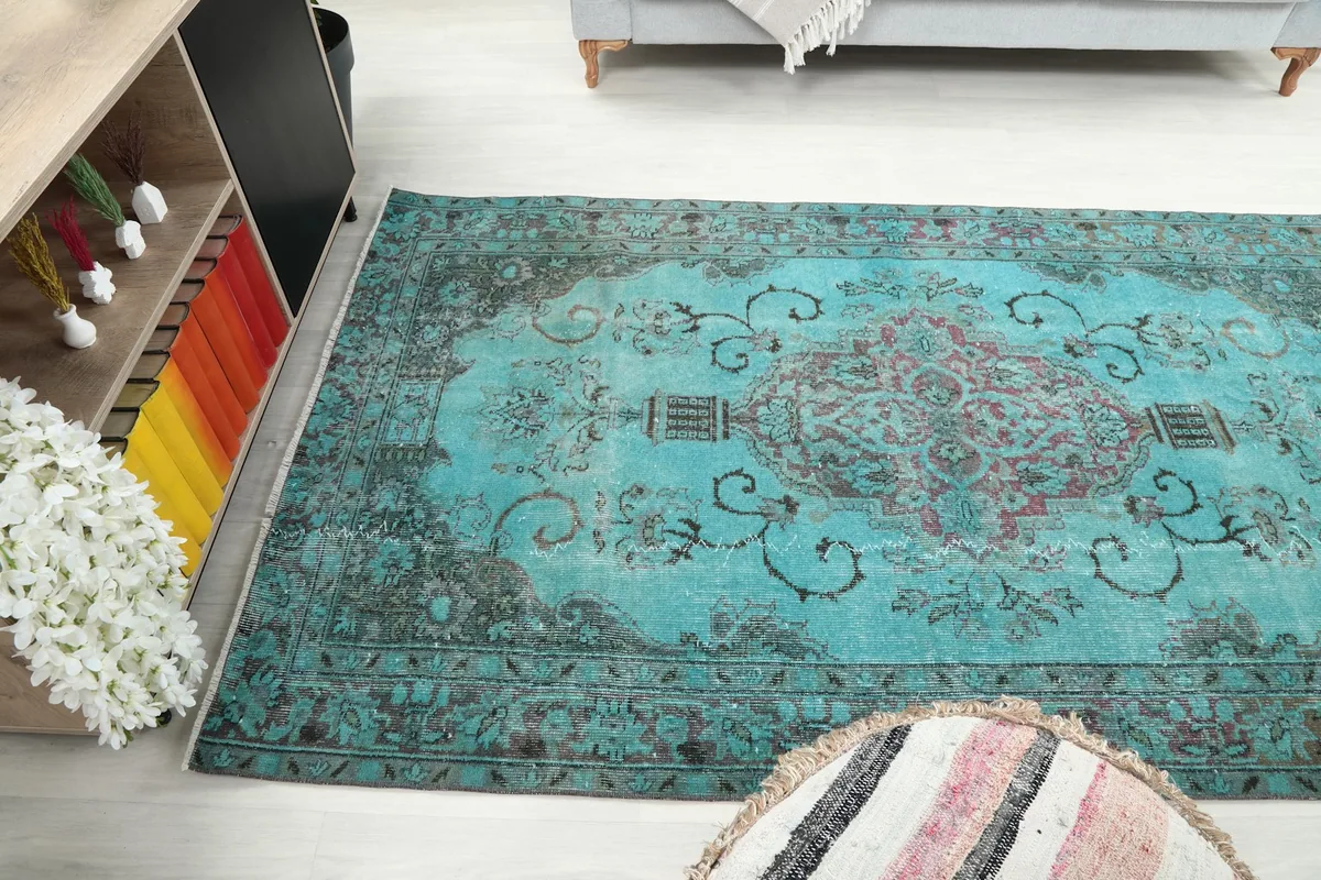 High angle room view of the blue rug, highlighting its placement and colors