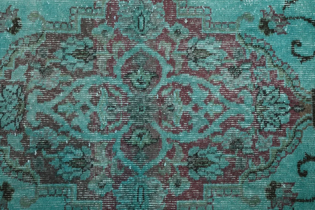 Macro view of the rich red and blue tones within the medallion design