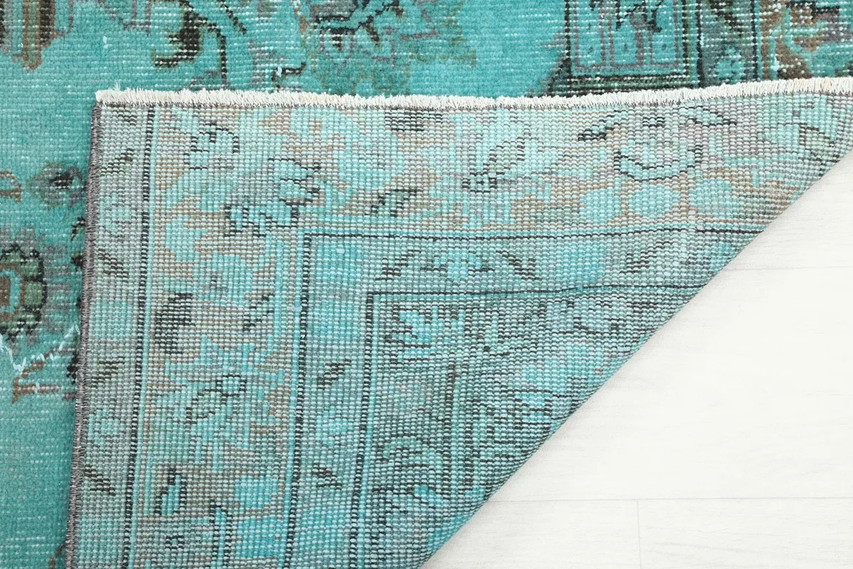 Underside of the rug, revealing the hand-knotted cotton foundation