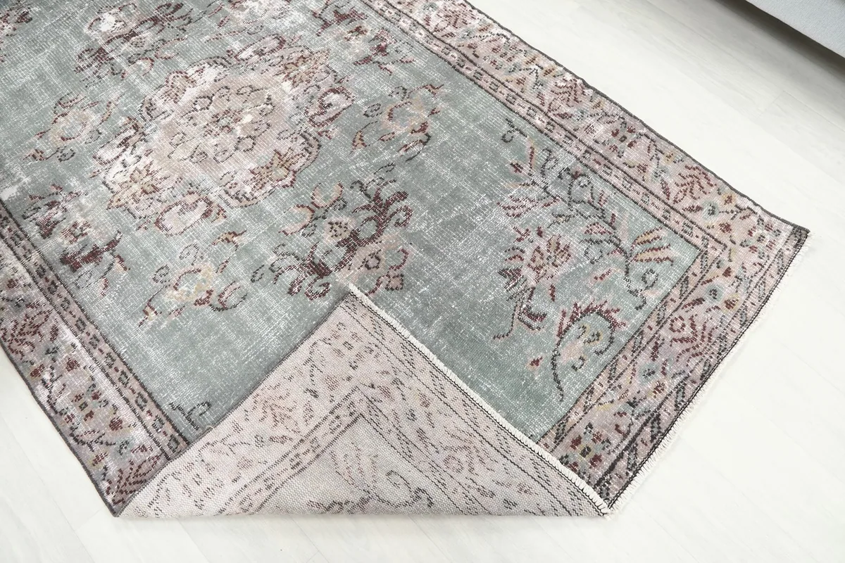 View of the rug's low wool pile and the texture of the hand-knotted construction