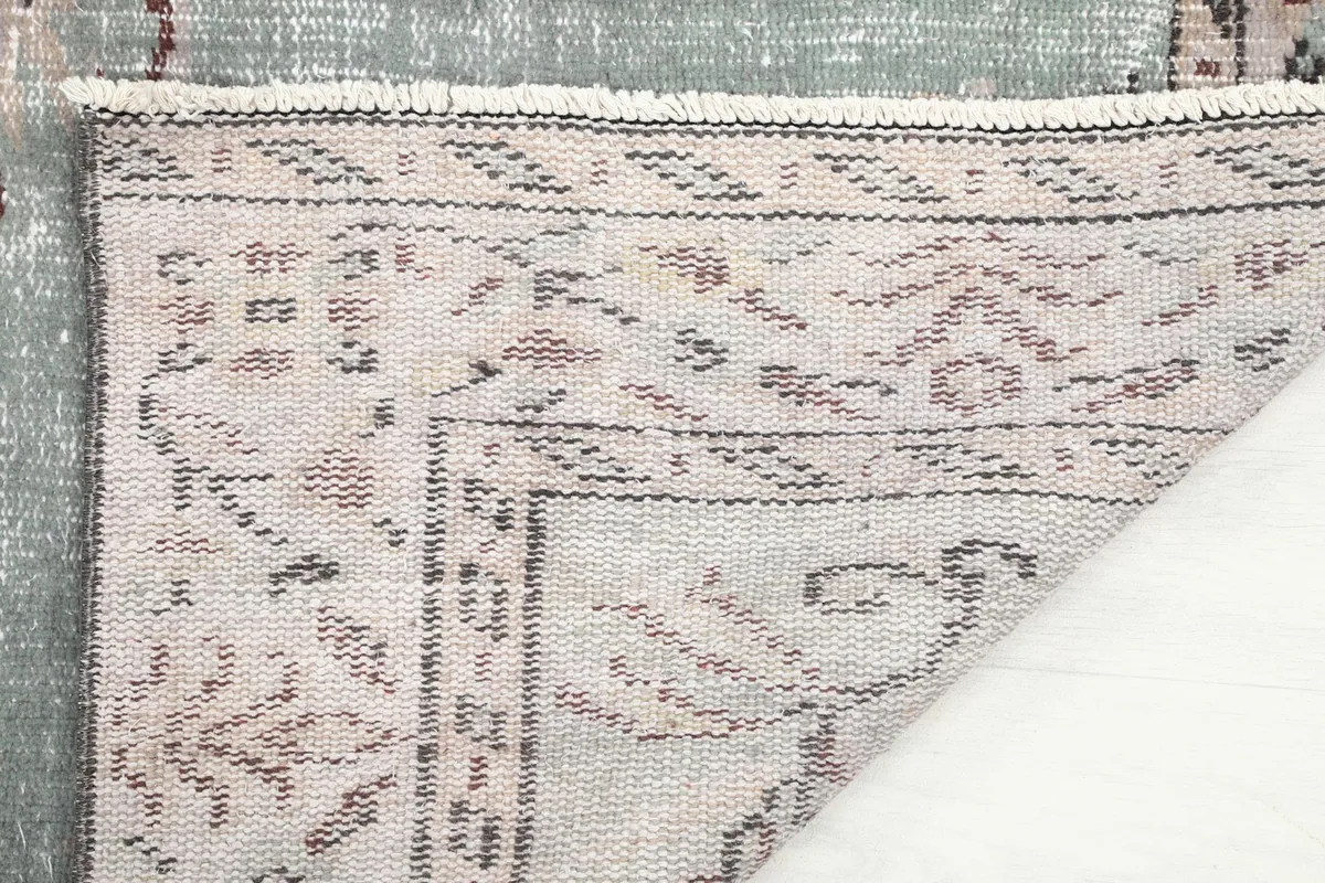 Reverse side of the rug, showing the cotton foundation and fine hand-knotting