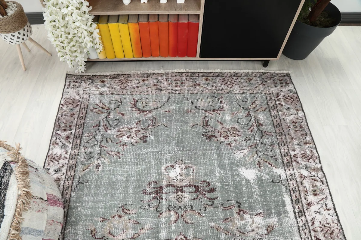 Overhead shot of the rug's top half, showcasing the overall pattern and faded appearance
