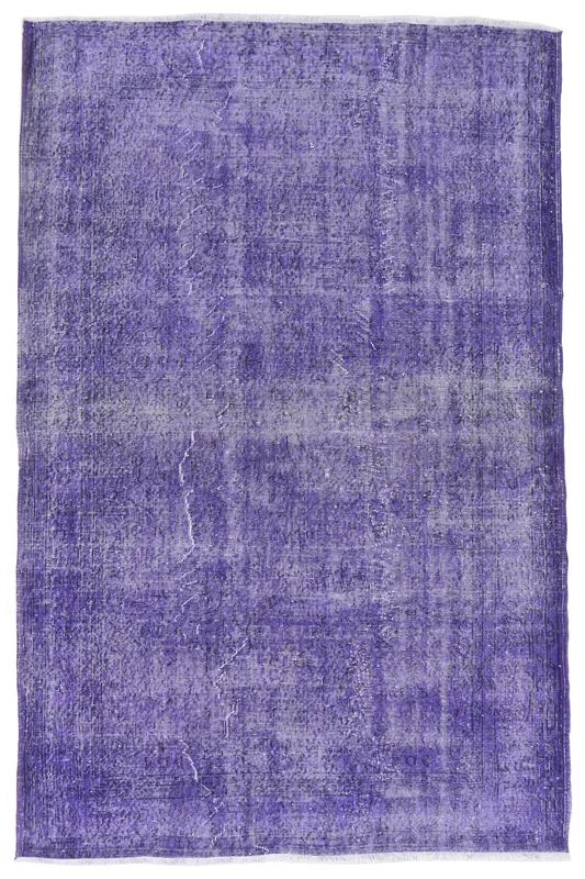 Full overhead view of the 5'7" x 8'7" purple distressed Anatolian area rug on a white background.