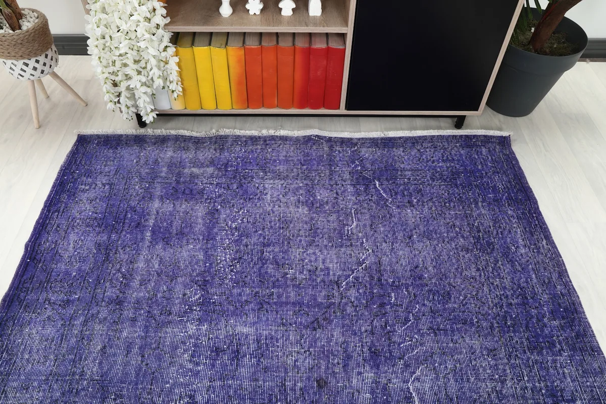 Overhead view of the purple rug in a room setting, showing its placement relative to a console table.