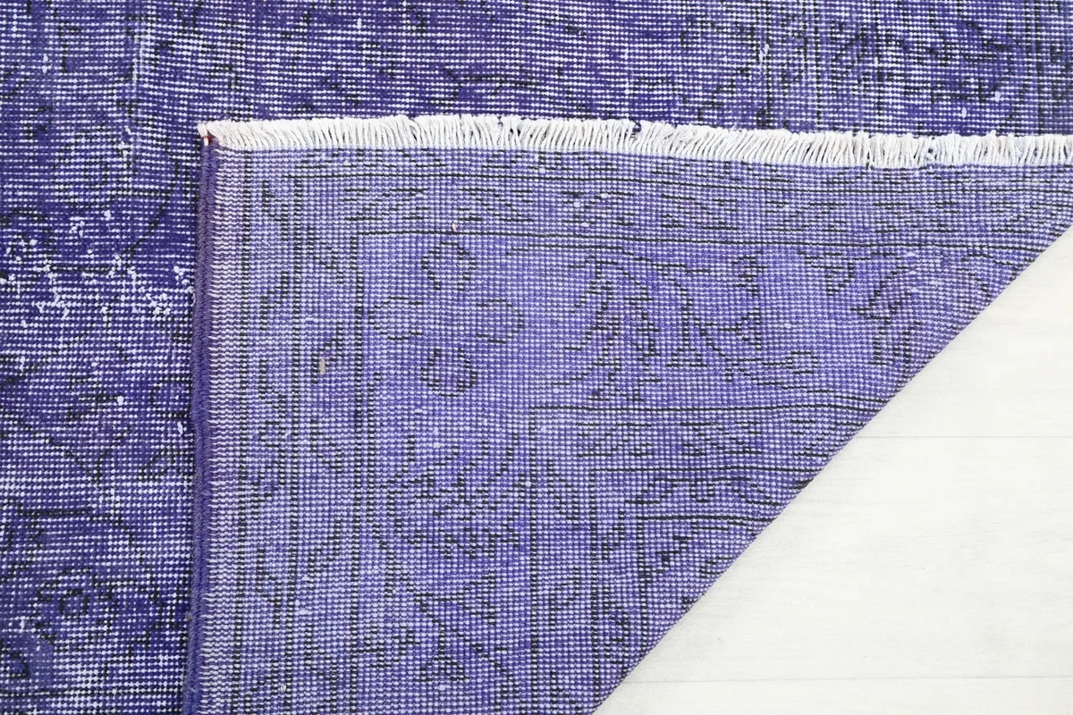 Closer detail of the rug's back, showing the tight knotting and the pattern visible on the foundation.