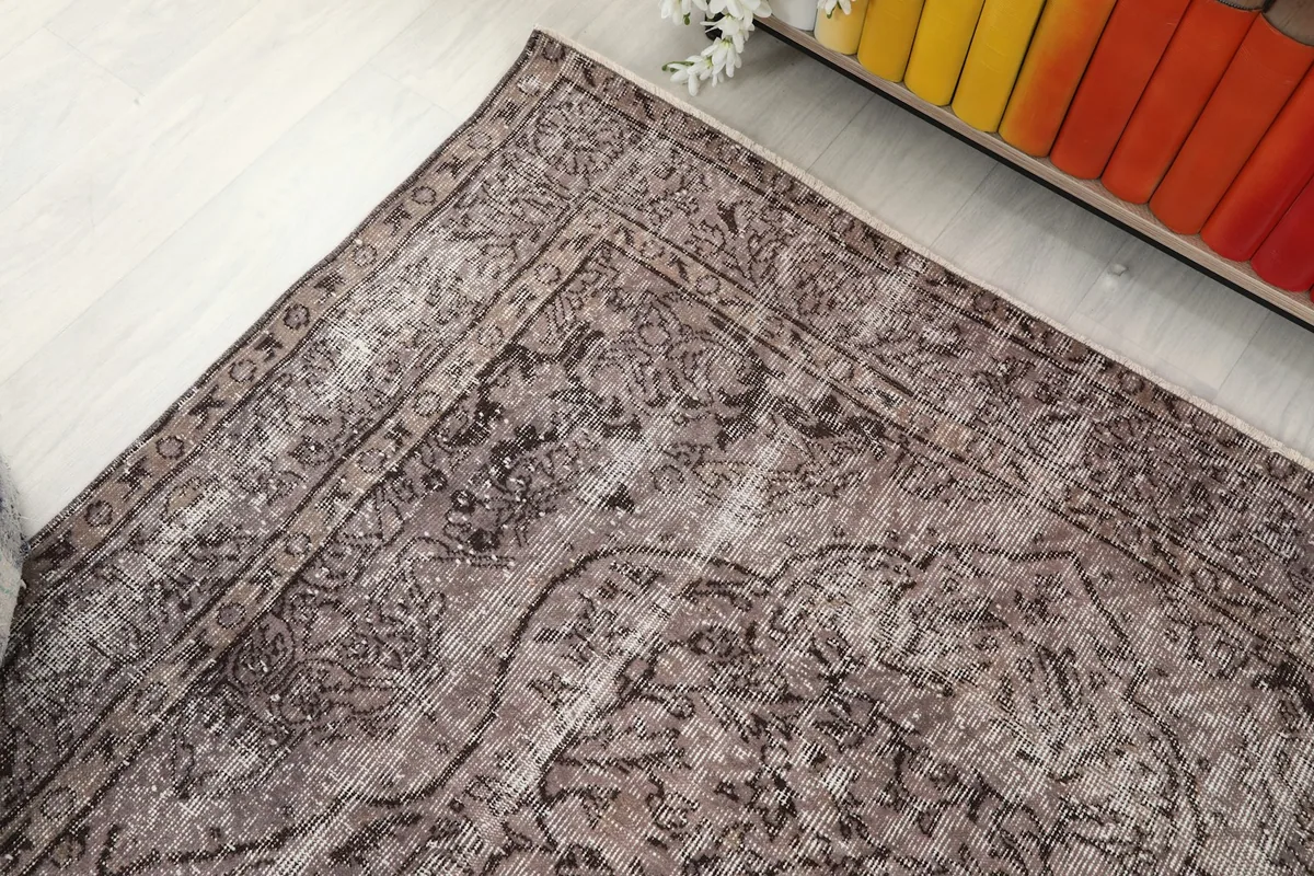 Overhead angle shot focusing on the upper left corner of the rug, displaying its border and main field design.