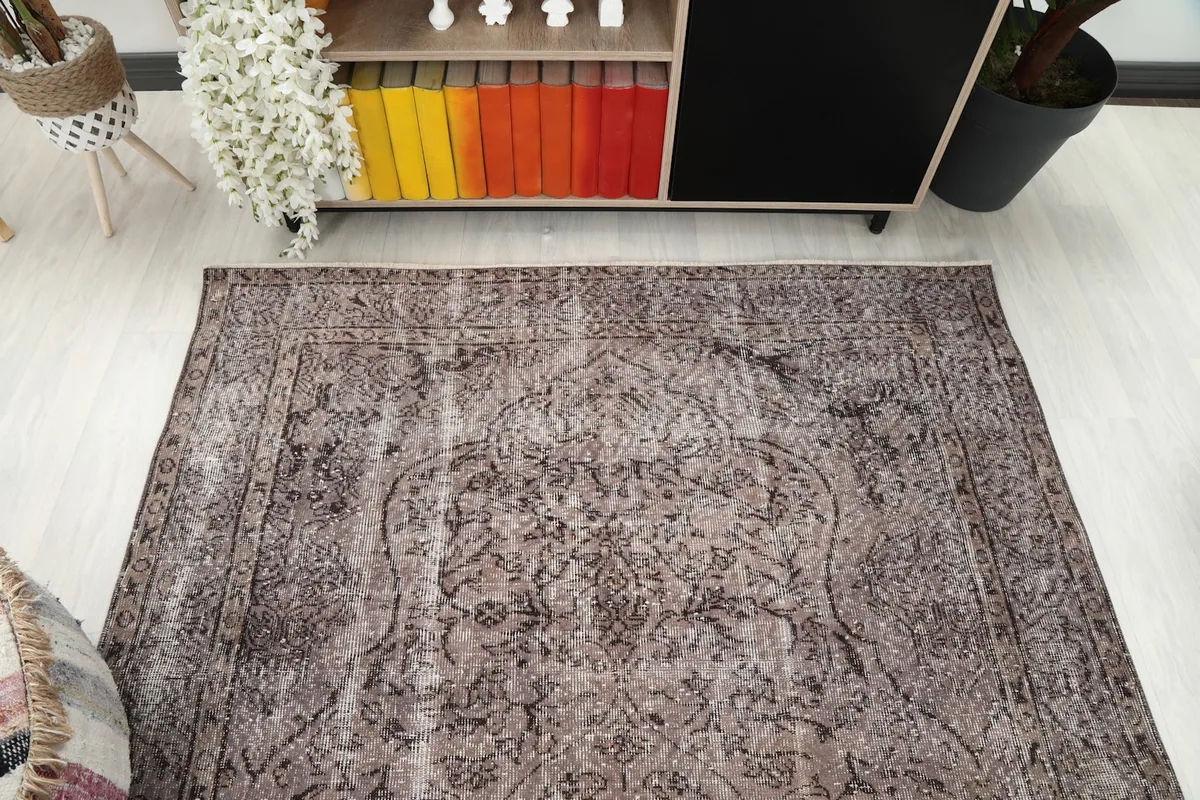 Overhead perspective of the charcoal gray rug, emphasizing the central medallion and overall pattern.