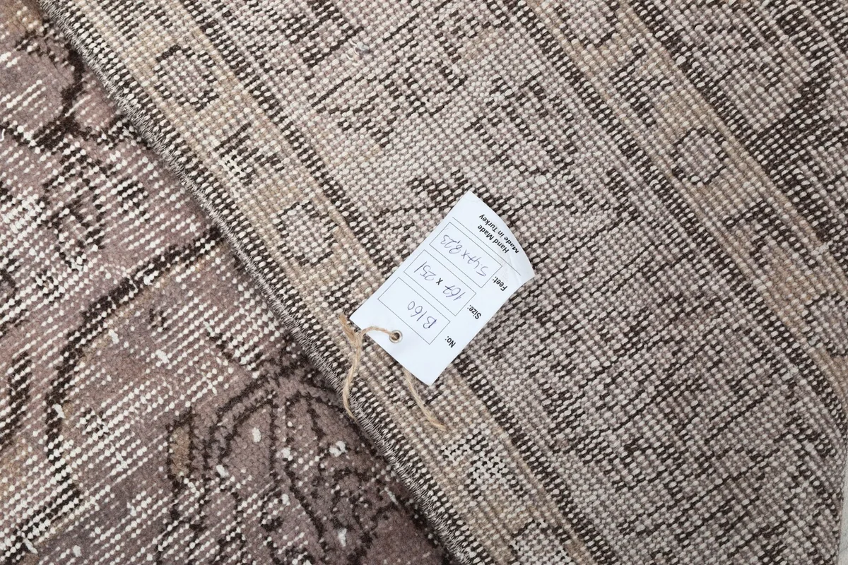 Detailed view of the rug's label attached to the back, indicating its size and origin.