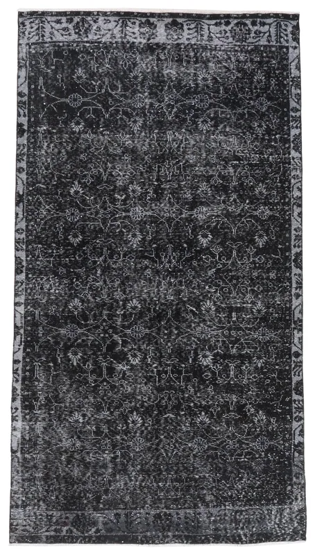 Full top view of the distressed black and gray floral vintage Anatolian rug