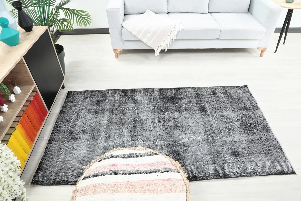 Overhead view of the charcoal gray rug in a room, capturing its overall presence and color.