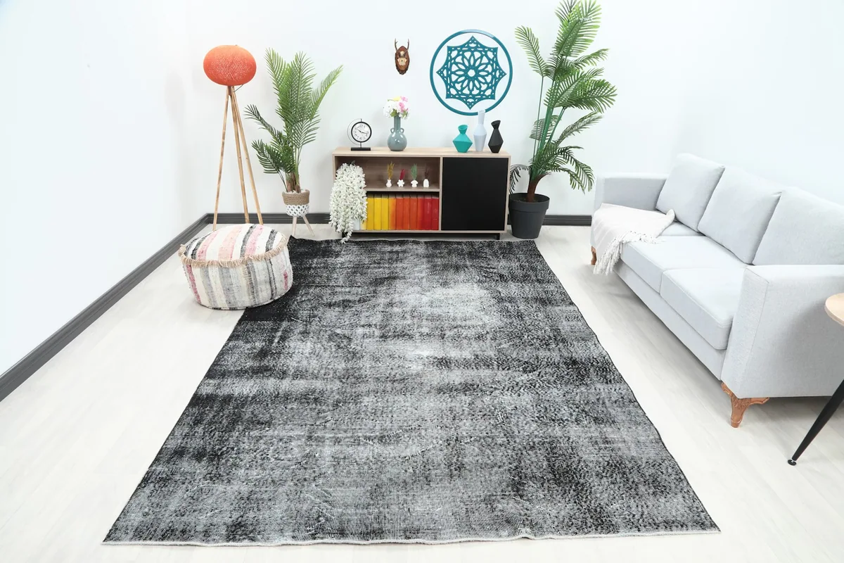 Charcoal and gray vintage Anatolian rug displayed in a living room setting