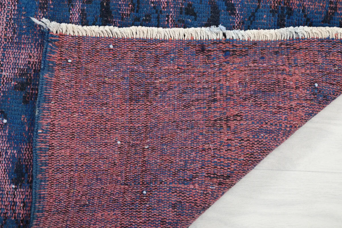 Close-up of the back of the hand-knotted rug, revealing its construction