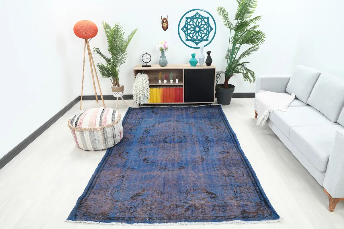 Vintage blue area rug in a modern living room setting with a light sofa