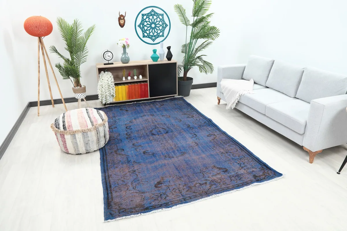 Angle view of the blue distressed rug in a contemporary room, showing its size