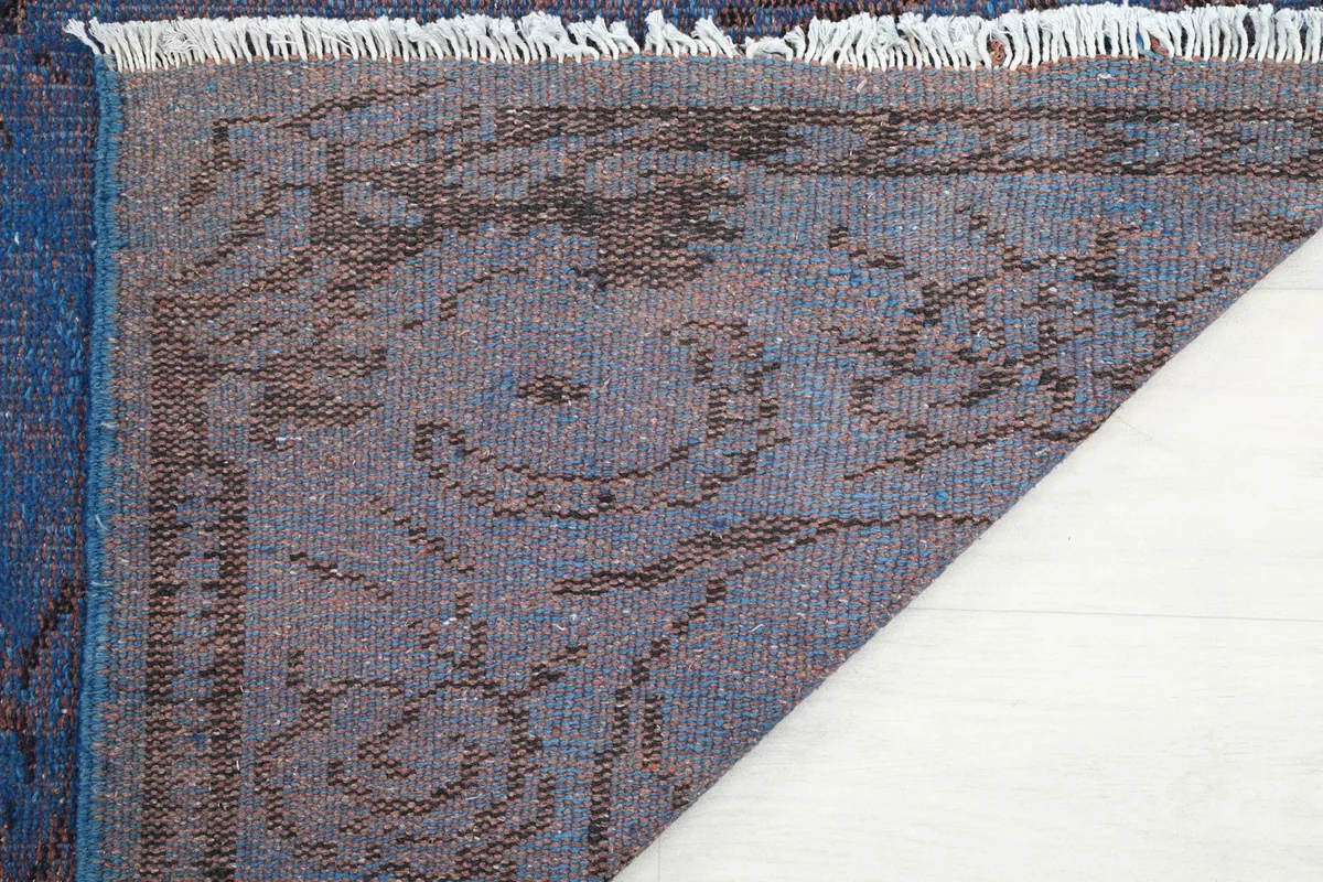Close-up of the underside of the rug, showing the knotting and fringe