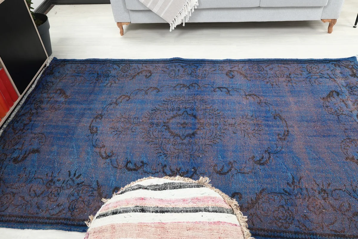 High angle view capturing the overall design and color variations of the blue rug