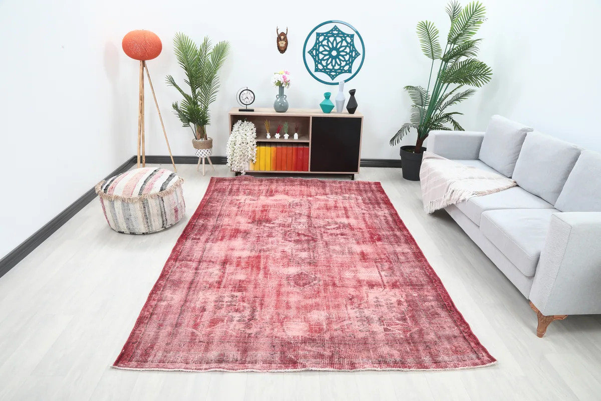 Faded Rose Geometric Vintage Rug in a modern living room setting, showcasing its medium size.