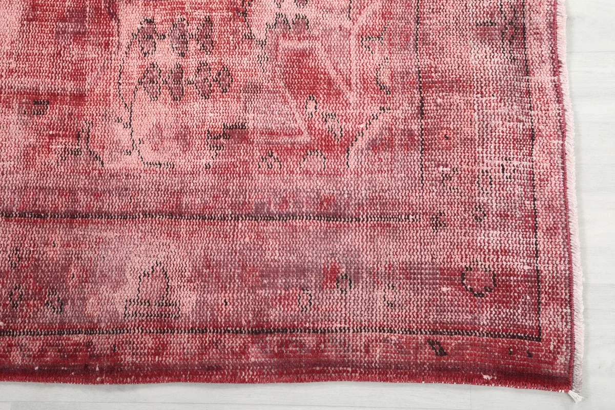 Detail of the border of the Faded Rose Geometric Vintage Rug, with subtle patterns visible.